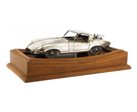 A cast and silvered Jaguar E-type desk lighter,modelled with a removable hood revealing an ashtray, the boot mounted with a l