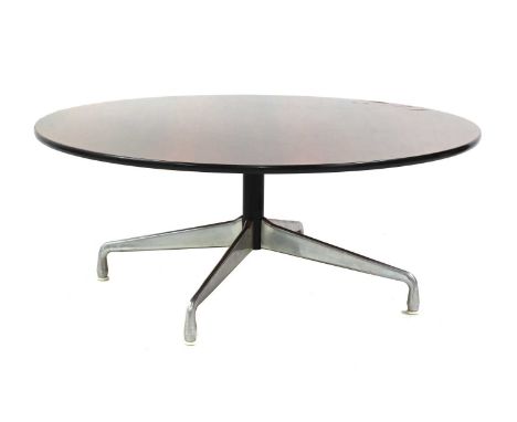 A circular rosewood coffee table, §designed by Charles and Ray Eames for Herman Miller, raised on an aluminium base, 122cm di