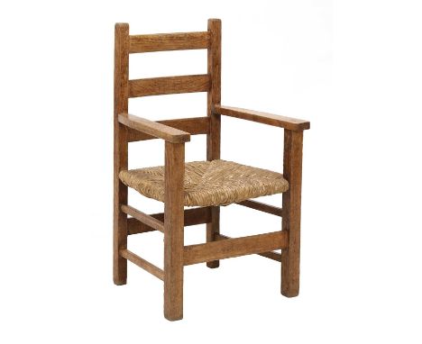 An Heal's 'Letchworth' oak child's armchair,of ladder backed design, with a rushed seat, raised on square supports, 40cm wide