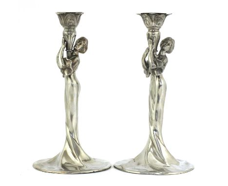 Two WMF silvered figural candlesticks,each modelled and cast as an Art Nouveau maiden holding a vase, the sconce with a circu