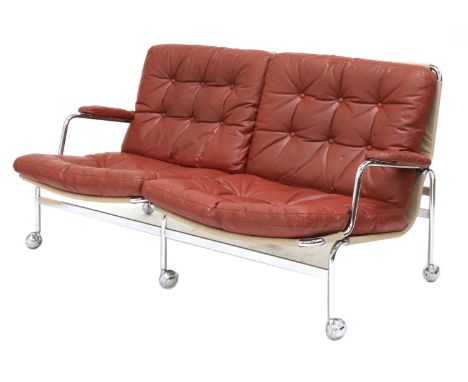 A 'Karin' two-seater sofa,1970s, designed by Bruno Mathsson for Dux, with a canvas slung tubular frame with buttoned cushions