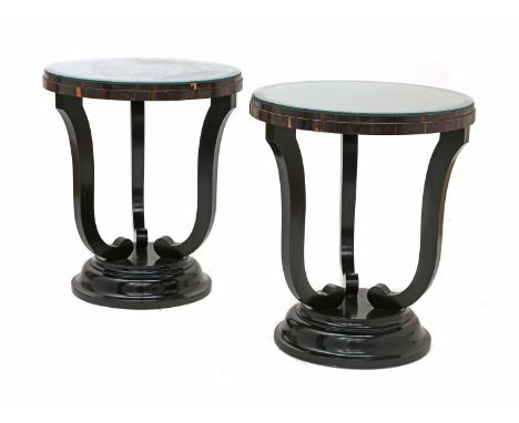 A pair of wenge lamp tables,each with a circular top, on an ebonised 'U' form column and stepped platform base,50cm diameter,