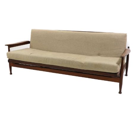 A teak daybed, 1970s, raised on baluster-shaped supports, with cushions upholstered in oatmeal fabric, 204cm wide87cm deep75c