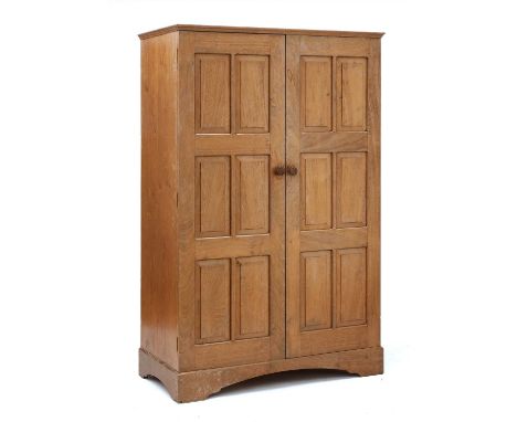 A Cotswold School walnut wardrobe,c.1952, by Keith Cooper, Old Chapel, Lytchett Matravers, Dorset, with a moulded cornice, ch