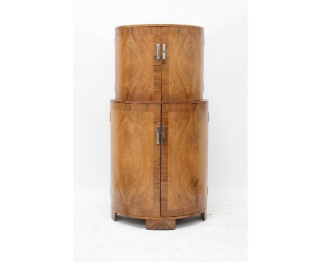 An Art Deco crossbanded walnut cocktail cabinet,of demilune form, with quarter-veneered cupboards, with chrome handles, the t