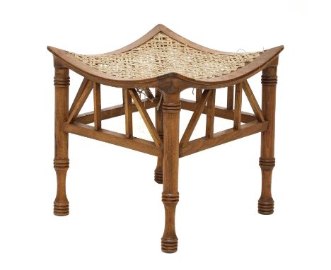 An oak Thebes stool,after the original design by Leonard Wyburd, raised on bobbin-turned supports joined by square stretchers