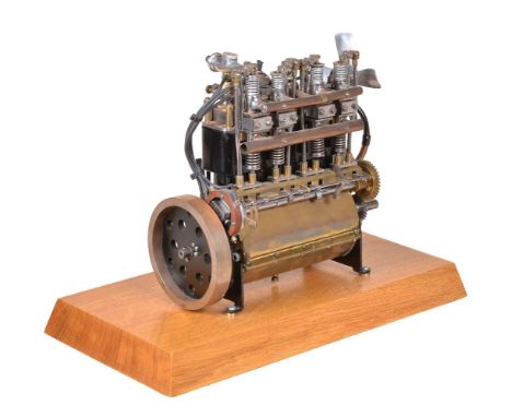 A well-engineered model of an overhead internal combustion four cylinder engine, with four fitted ignition plugs, carburetor 