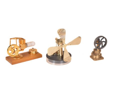 A small vertical live steam engine, a Hog Motor hot air engine and a fan on circular base.(3)