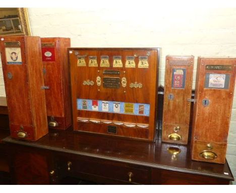 Five vintage wooden cigarette vending machines