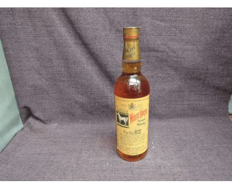 A bottle of 1960's White Horse Blended Scotch Whisky no 6288144, 70 proof, no capacity stated, pink label to reverse, screw t