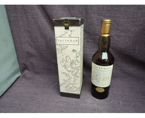 A bottle of 1990's Talisker 10 Year Old Single Malt Scotch Whisky, Old Map Label Classic Malt Series, 45.8% vol, 70cl, in car