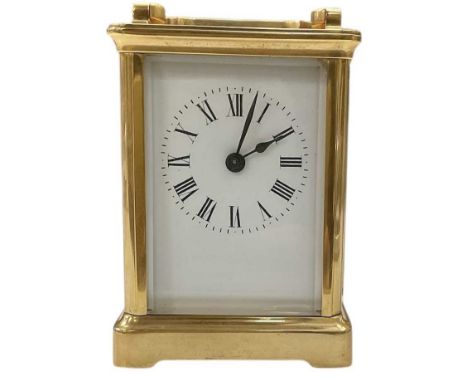 An early 20th century French brass cased carriage clock, the white enamel dial set with Roman numerals and subsidiary seconds