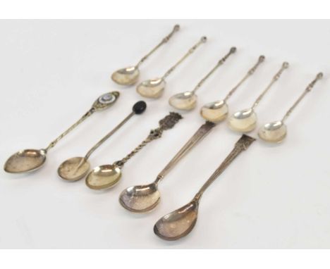 A set of six white metal teaspoons, the finials modelled as claws holding an egg, length 9.5cm, also four further white metal