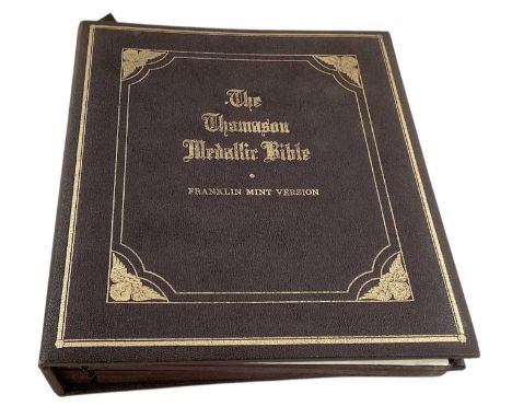 FRANKLIN MINT; 'The Thomason Medallic Bible', with five pages containing sixty-two commemorative bronze and gilt medallions.