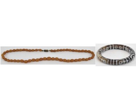 A small amber bead effect necklace, length approx 40cm and a banded agate bangle, with white decoration, diameter 7.5cm (af) 