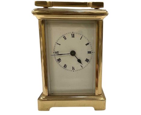 An early 20th century French brass cased carriage clock, the white enamel dial set with Roman numerals and subsidiary seconds