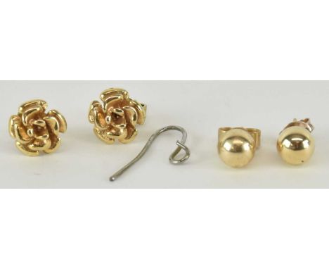 A pair of 9ct yellow gold floral ear studs and a further pair of yellow metal ear studs, combined weight approx 2.3g.