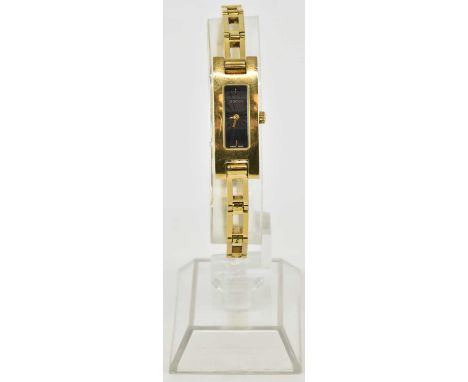 GUCCI; a lady's model 3900L gold plated wristwatch with tank style head, the black dial set with single baton markers at 12 a