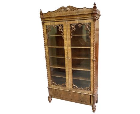 A Victorian walnut display cabinet, with pair of glazed doors with fret carved decoration and barley twist columns, height 19