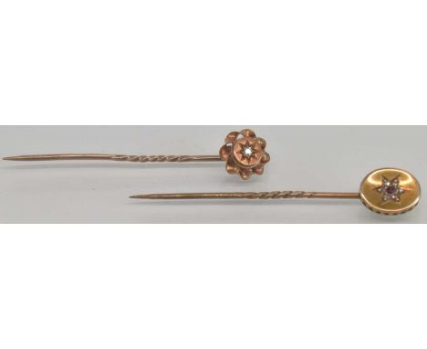 A 15ct yellow gold ruby and diamond set stick pin, length approx 5.2cm, and a 15ct yellow gold diamond set stick pin, length 