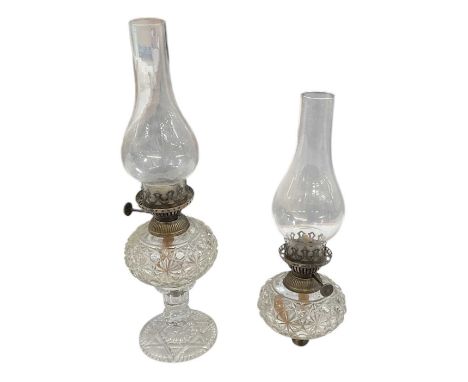 A pair of early 20th century cut glass oil lamps, with silver plated mounts and clear glass chimneys, height to top of chimne
