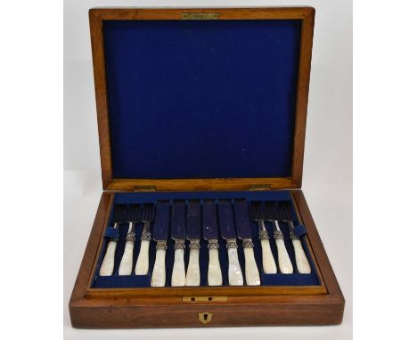 A late 19th/early 20th century walnut and oak cased twelve setting canteen of silver plated and mother of pearl handled knive