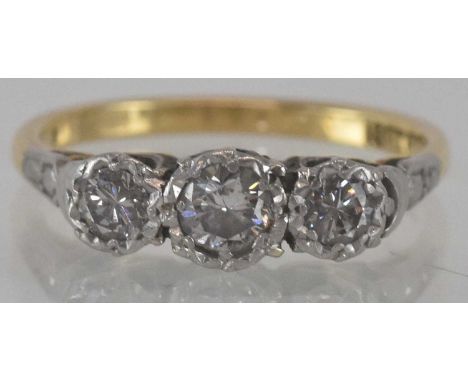 An 18ct yellow gold platinum diamond three stone ring, the central illusion set stone, approx 2ct, flanked by two illusion se