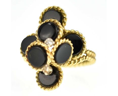 An 18ct gold contemporary ring with six black onyx pebbles and two small claw set diamonds, with rope twist edge, split shoul