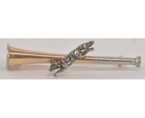 A yellow and white metal bar brooch, modelled as a hunting horn/bugle, set with diamond encrusted figure of leaping fox, with
