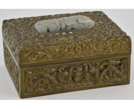 A late 19th century Chinese embossed brass rectangular trinket box, with traces of applied jewelled detail and decorated with