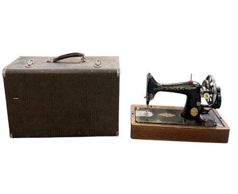 A cased Singer sewing machine.