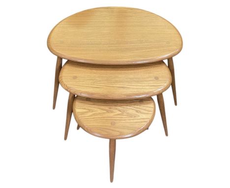 ERCOL; a mid century nest of three medium elm 'pebble' occasional tables, largest 65 x 45cm.