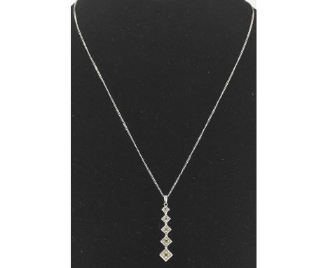 A 9ct gold graduated square drop pendant, each square set with small green stone, on a 9ct white gold dainty chain with ring 