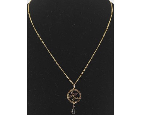 A 9ct gold circular necklace pendant, with three amethyst leaf flowers to the centre and amethyst pear shaped drop, on a 9ct 
