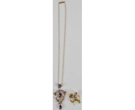 An Edwardian amethyst and seed pearl set pendant, length 6cm, suspended on a 9ct dainty chain with cylindrical box clasp, len