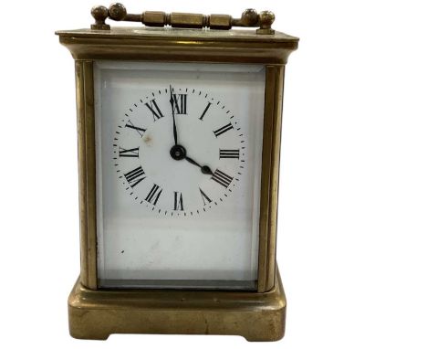 An early 20th century French brass cased carriage clock, the white enamel dial set with Roman numerals and subsidiary seconds