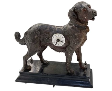 An early 20th century bronzed spelter mechanical mantel clock modelled as a dog, raised on stepped ebonised plinth base, heig