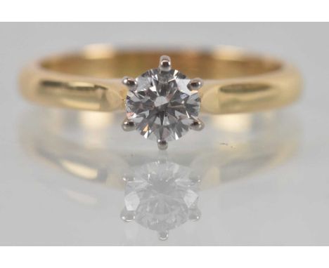 An 18ct yellow gold diamond solitaire ring, the central round brilliant cut stone approx 0.4ct, colour E, clarity SI1 and cut
