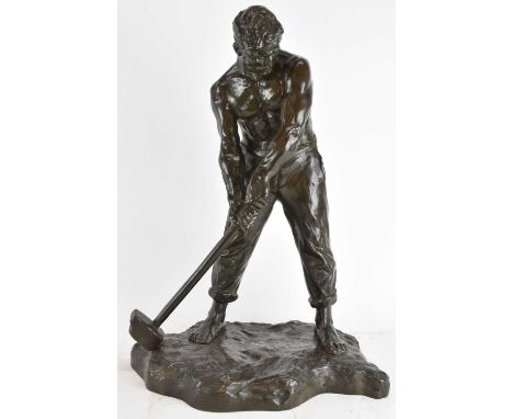 † VICTOR DEMANET; a large bronze figure, labourer carrying a hammer, raised on integral shaped base, signed, height 55cm.