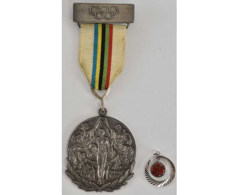 A London 1908 Olympic Games participation medal, white metal suspended on multicoloured ribbon, the medallion 4.8 x 4.5cm.