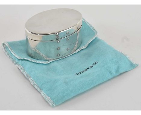 TIFFANY &amp; CO; a modern sterling silver oval lidded trinket box, with felt lined interior and studded decoration, 8 x 5.5c