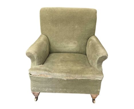 IN THE STYLE OF HOWARD &amp; SONS; a late 19th/early 20th century green upholstered library chair, with one castor stamped 'F