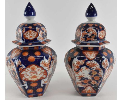 A pair of early 20th century Japanese Imari decorated hexagonal lidded jars, both height 32cm.