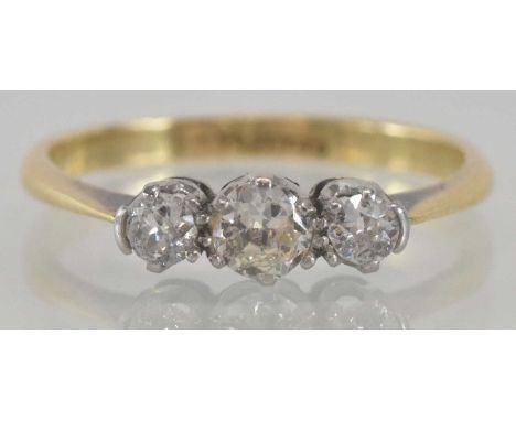 An 18ct yellow gold diamond set three stone ring, the central stone approx 0.2ct, flanked by two further round brilliant cut 