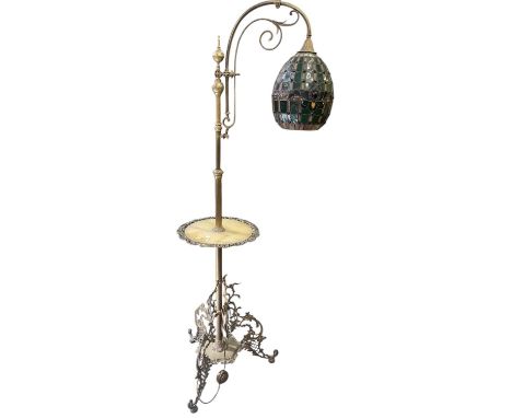 A late 19th/early 20th century brass framed standard reading lamp, with onyx set table and leaded coloured glass shade, heigh