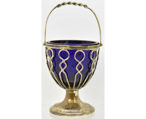 An Edwardian hallmarked silver basket, with swing handle and cobalt blue glass liner, London 1903, height including handle 14