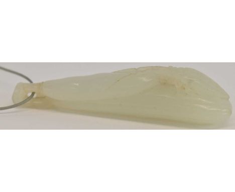 A Chinese carved jade pendant, decorated with a beetle and pod, length 8cm.