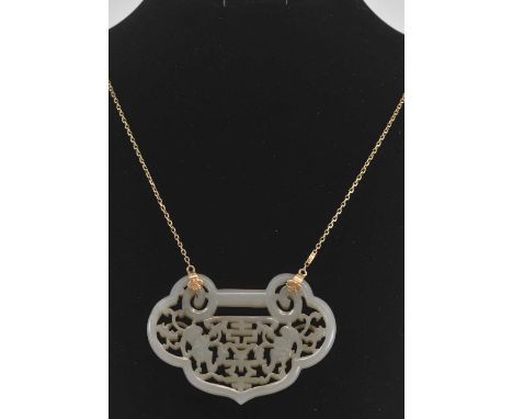 A Chinese pierced jade plaque, suspended on a yellow metal chain stamped '18K', the plaque length 7.5cm, length of chain 84cm