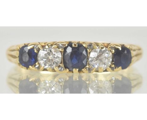 An 18ct gold diamond and sapphire set ring, with three claw set cut sapphires separated by two small cut diamonds, size N, ap