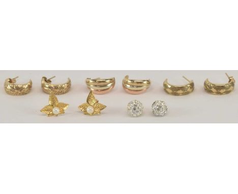 A pair of 9ct tri-coloured gold earrings, a pair of yellow metal pearl set stud earrings modelled as leaves, and three furthe